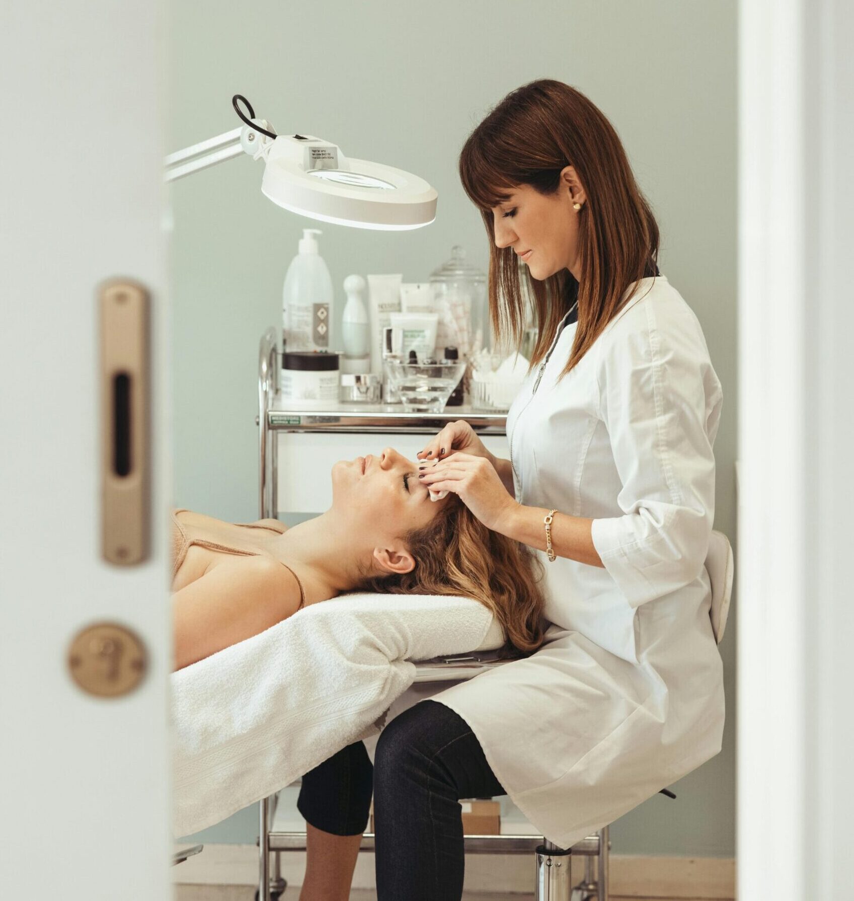 Beautician performs facial treatment in salon, enhancing skincare and relaxation.